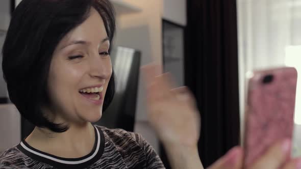 Woman Having Video Chat Using Smartphone Enjoying Chatting To Friend alt