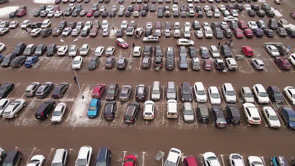 Cars Stand in Straight Rows in a Huge Parking Lot Aerial View alt