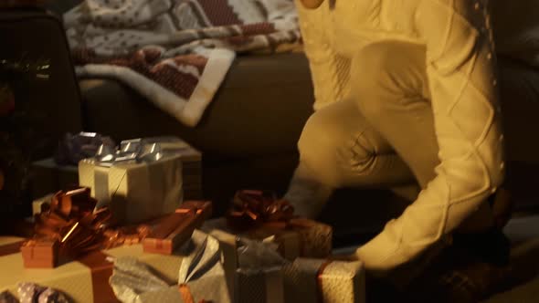 Boy receiving beautiful gifts on Christmas eve