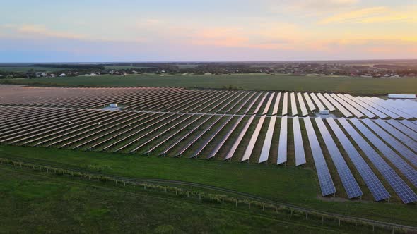 Aerial View of Large Solar Panels at a Solar Farm at Bright Summer Sunset. Solar Cell Power Plants alt