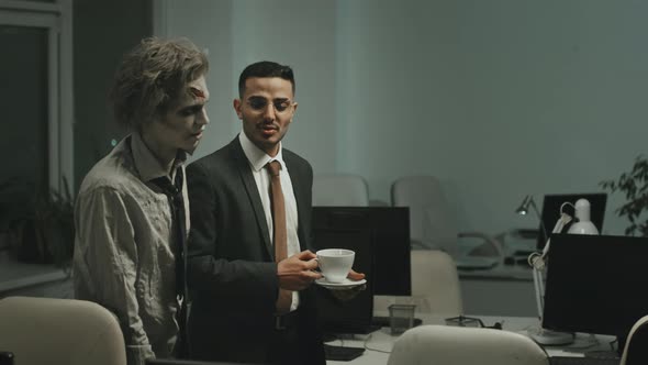 Successful Businessman Talking to Zombie Office Worker alt