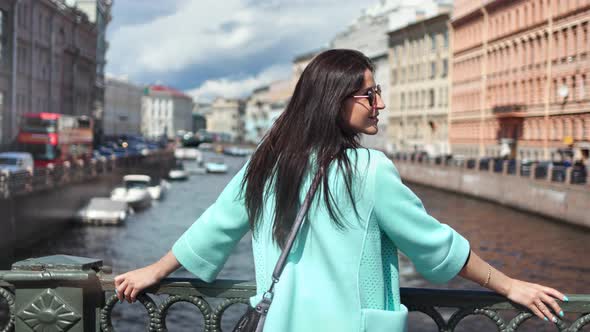 Adorable Brunette Travel Woman Standing on Bridge Admiring Amazing River Cityscape Enjoying Holiday alt