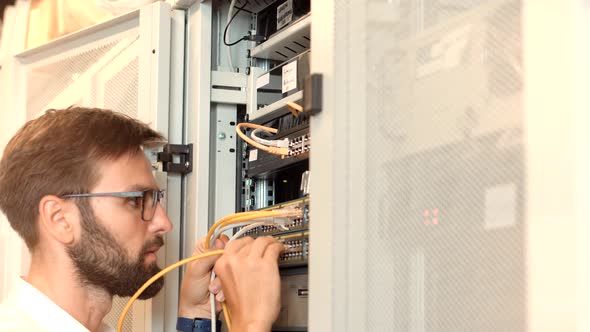 It Administrator In Mining Server Room And Connecting Ethernet Wire.Cloud Computing Mining Equipment alt