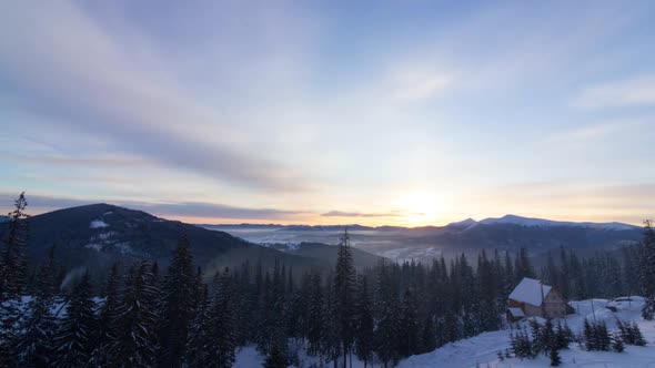 Aerial View of Sunrise in Winter Forest Mountains with Lot of Snow and Snowy Trees in Cold Morning alt