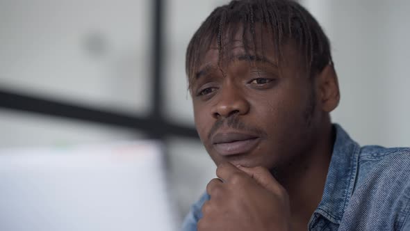 Closeup of Thoughtful Young Man Planning Business Idea Thinking alt