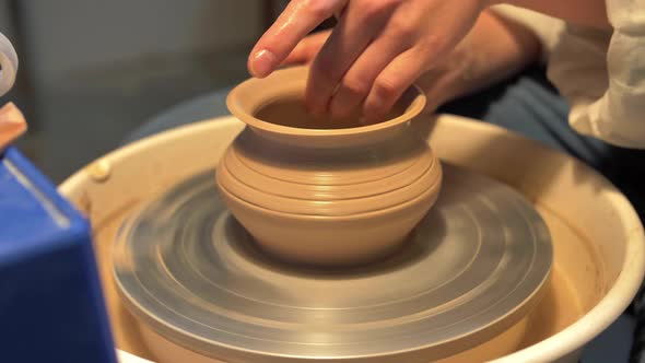 Woman Makes a Pot on a Pottery Wheel in a Workshop, Slow Motion alt