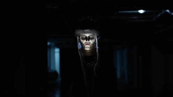 Creepy Man with Skeleton Makeup Appearing From Darkness When Light Falls on Him, Making Faces alt