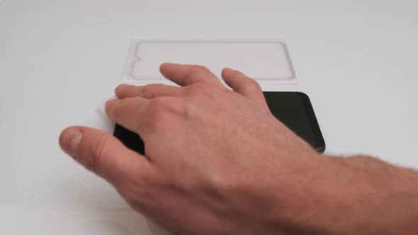 Sticking Protective Glass on the Smartphone Screen Change Cracked Safety Glass alt