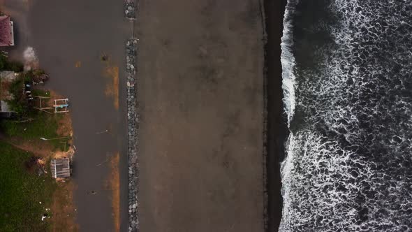 Birds eye view along black sand beach Bali alt