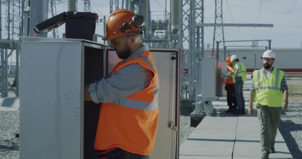 Engineers Fixing Transformer During Inspection alt