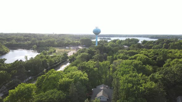 Drone view over Excelsior, Minnesota, toward Lake Minnetonka on a bright summer day.