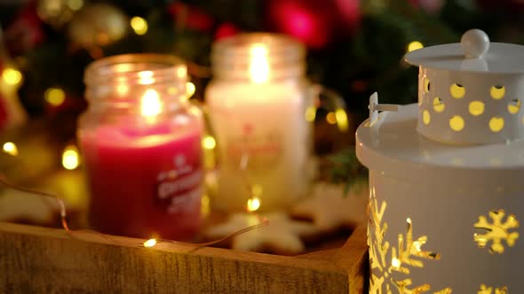 Two burning candles in beautiful decorative Christmas jars