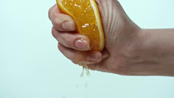 Female hand squeezing orange alt