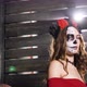 Model with Skull Makeup Poses Against Wooden Wall in Studio - VideoHive Item for Sale