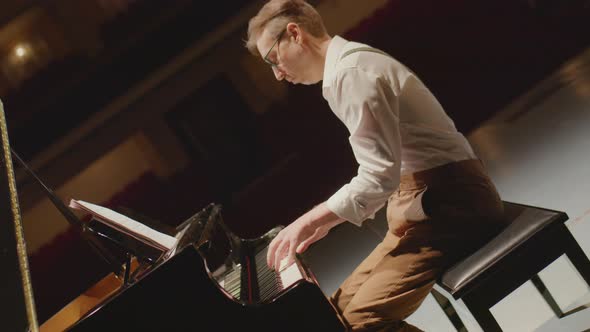 Pianist Playing Piano in Concert Hall alt