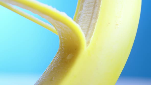 Macro Lens Shot Fresh Banana Gets Peeling on a Blue Background alt