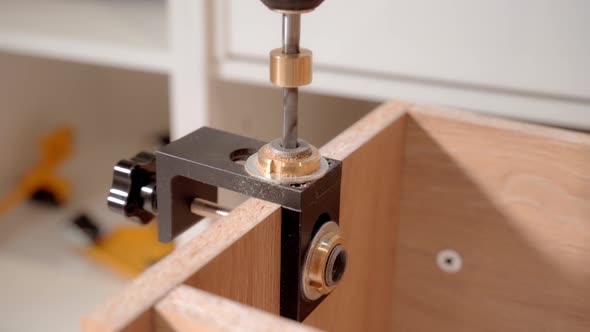 The Master Uses a Jig Template and an Electric Screwdriver to Drill Holes When Assembling the alt
