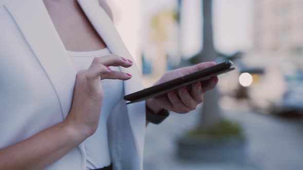Closeup of Young Businesswoman Using Tablet Outdoors