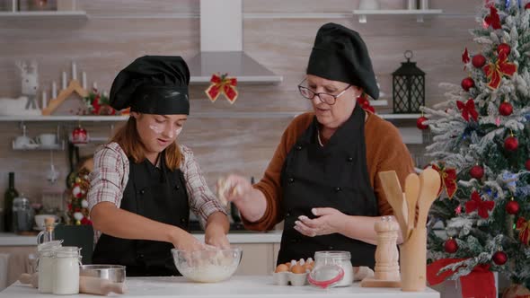 Grandchild Wearing Apron Preparing Homemade Winter Biscuits Dough in Culinary Kitchen alt