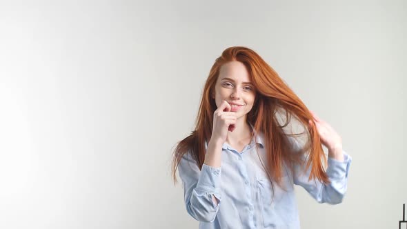 Portrait of Young Attractive Redhead Girl Smiling Looking at Camera. Slow Motion.