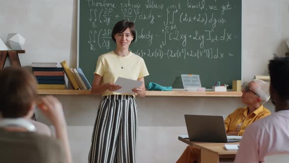 Female Student Reciting Lesson in front of Classmates and Teacher ...