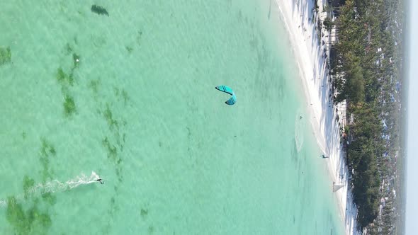 Zanzibar Tanzania  Vertical Video Kitesurfing Near the Shore of Ocean Slow Motion alt