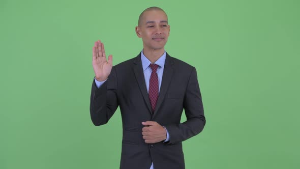 Happy Bald Multi Ethnic Businessman Waving Hand alt
