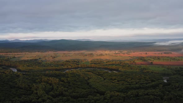 Aerial Drone View of Sunrise Over Misty River alt