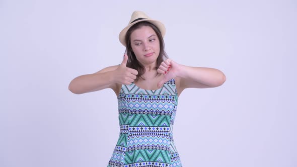 Confused Young Tourist Woman Choosing Between Thumbs Up and Thumbs Down alt