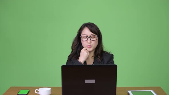 Mature Beautiful Asian Businesswoman Using Laptop alt