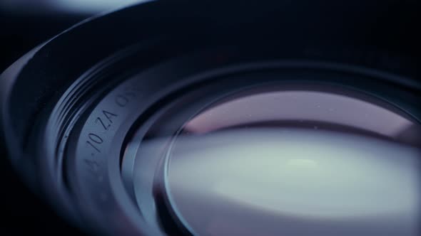 the lens of a movie camera or photo camera is shot in close-up alt