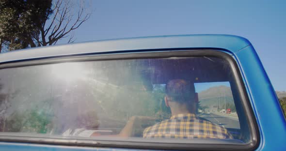 Young couple on a road trip in their pick-up truck alt
