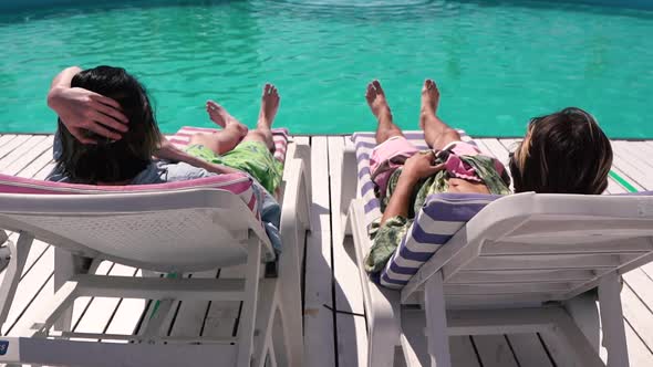 Young Men Chilling on the Sun Lounger alt