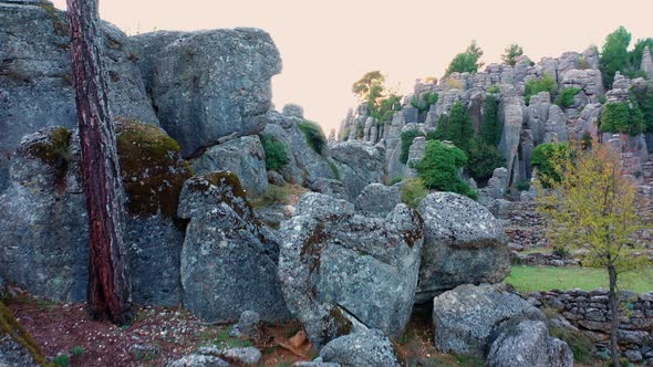 Picturesque Rock Formations with Lush Green Pine Trees at Mountain Valley alt