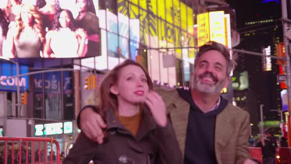 Couple sitting together talking in Times Square, New York City