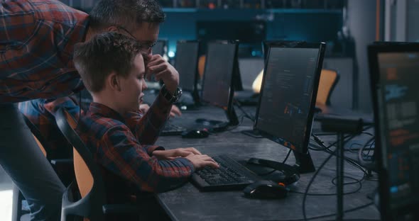 Student and Teacher Discussing Programming in School alt