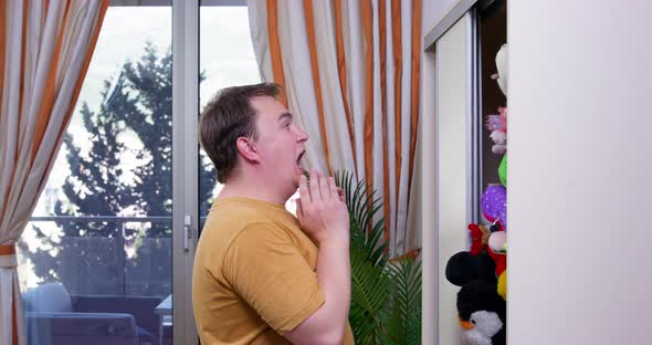 Plump Man Gets Scared Opening Wardrobe with Falling Toys