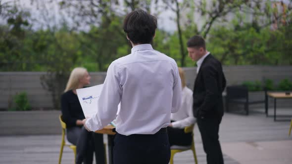 Live Camera Follows Confident Business Analyst Walking with Graph in Slow Motion to Colleagues on alt