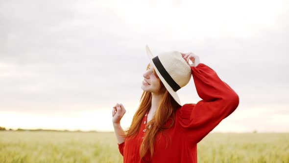 Slow Motion Happy Redhead Girl Walking on Wheat Field and Smiling Carefree