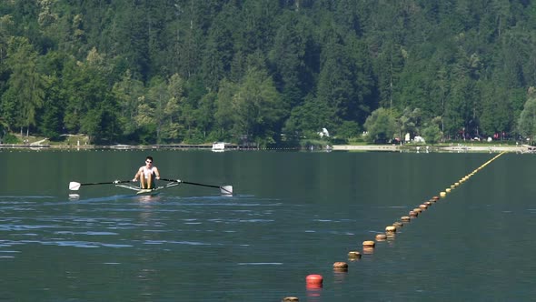 Strong Male Training in Rowing on Lake, Healthy Lifestyle, Professional Sport alt