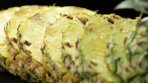 Pineapple in Slices Gyrating on Black Background alt