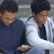 Poor homeless african american male friends counting money - VideoHive Item for Sale