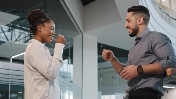 Two Coworkers Friendly Diverse Business Partners Colleagues African Woman with Arabian Indian Man alt