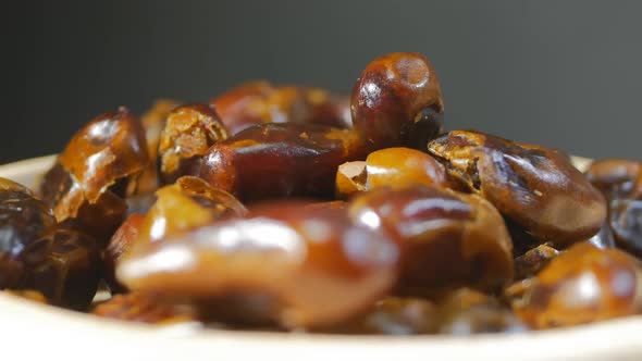 Turkish Sweet Dates Rotate in a White Wood Plate