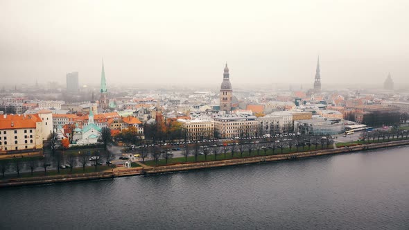 Drone Is Descending Over Beautiful Aerial Panorama of Riga Old Town with Car Traffic Along Daugava alt