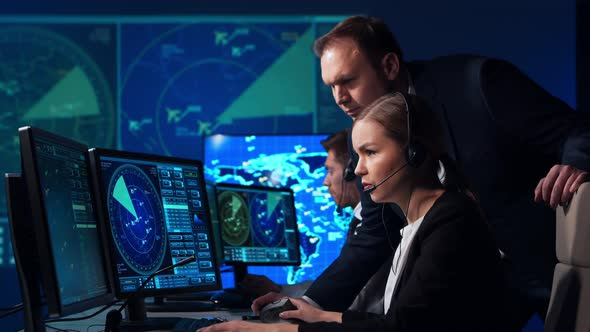 Workplace of the air traffic controllers in the control tower. Team of professional officers. alt