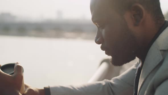 Portrait of African American Businessman with Coffee Outdoors alt