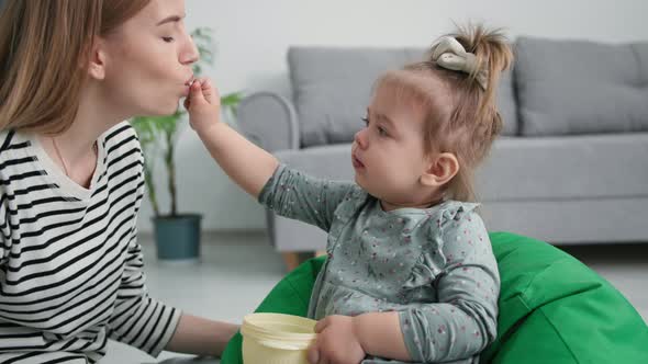 Motherhood Cute Little Daughter Feeds Her Mom with Sweet Grapes Caring Female Parent Kiss Little alt