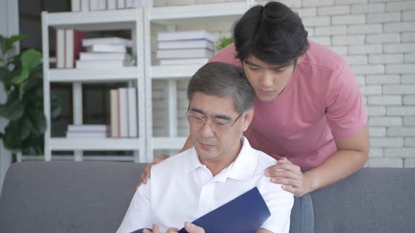 Family concept. The son encourages a father who is stressed from work. 4k Resolution. alt