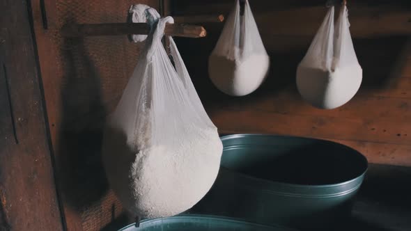 An Old Cheese Dairy. Fresh Cheese in Gauze Is Hung in a Traditional Wooden House alt